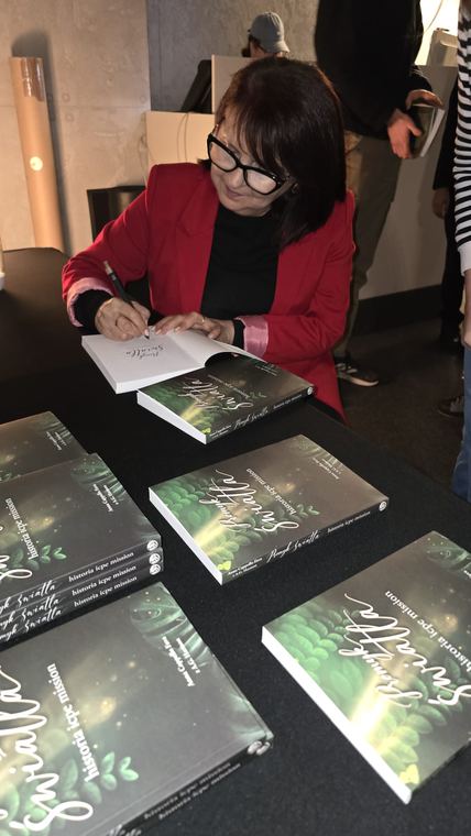 Signing books after the launch